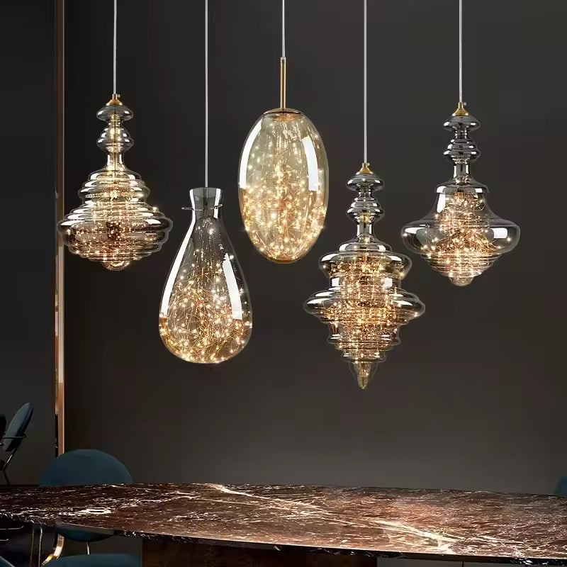 Composition de cinq suspensions en verre soufflé fumé aux formes sculpturales et éclats dorés, dans un style Art déco raffiné.